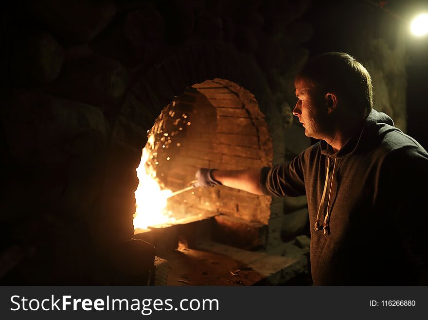 Man preparing fire in stove