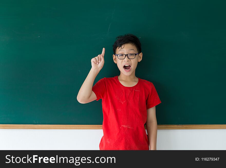 Asian student boy thinking answer for question in class room at school. Asian student boy thinking answer for question in class room at school