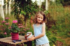 Happy Child Girl Decorating Evening Summer Garden With Candle Holder Stock Images