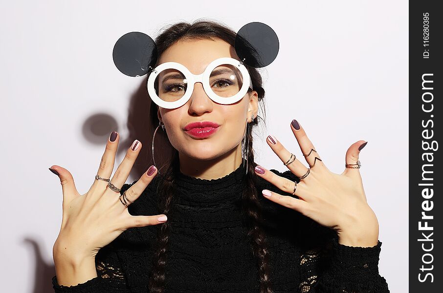 Fashion concept. Beauty surprised fashion model girl wearing big sunglasses. Young girl. Makeup.