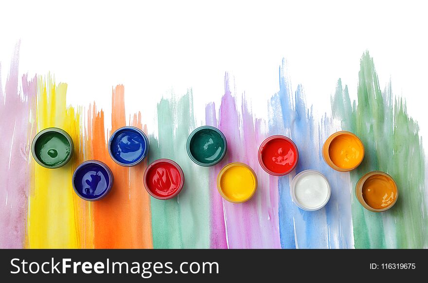 Composition with different paints in jars on light background, top view. Color palette