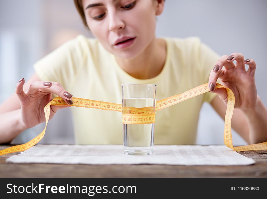 Refreshing drink. Selective focus of a glass with water standing on the table. Refreshing drink. Selective focus of a glass with water standing on the table