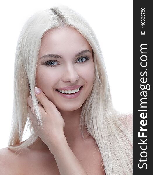 Close-up of a beautiful woman with blond hair touching her face with hands