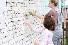 Girls Kids Paint The Walls With A Roller Stock Photos