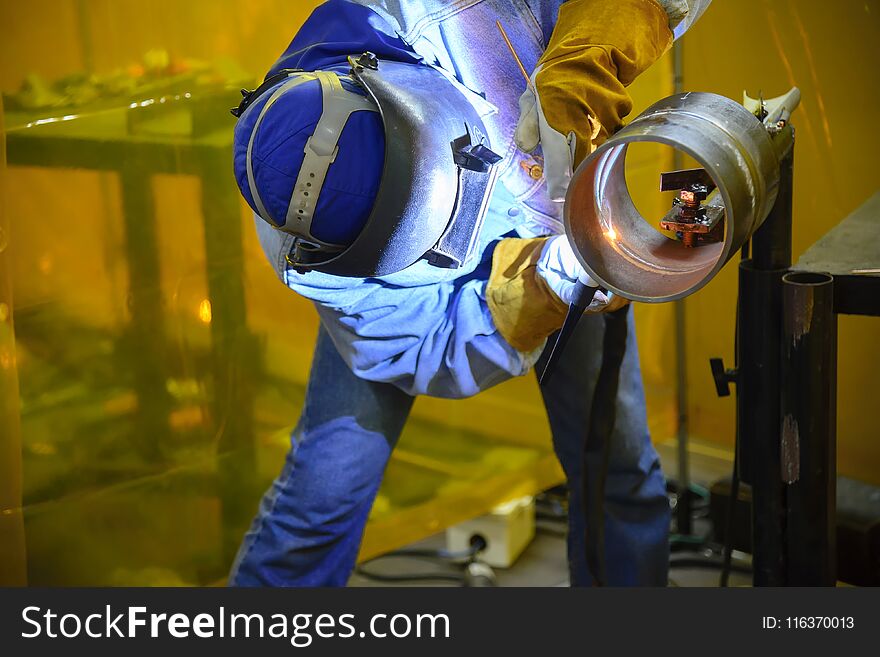 Skill welding operator welding the steel pipe