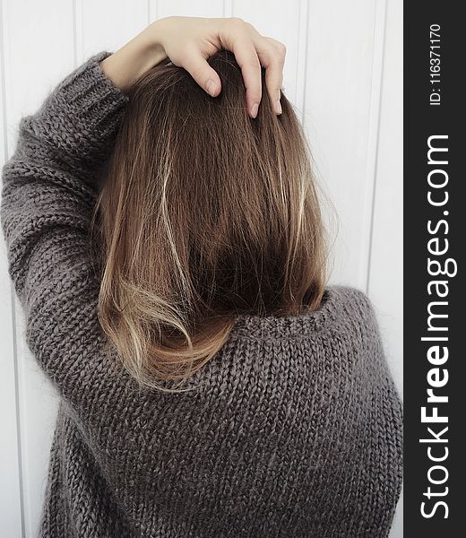 Woman Wearing Black Crew-neck Knitted Long-sleeved Shirt Beside White Wall