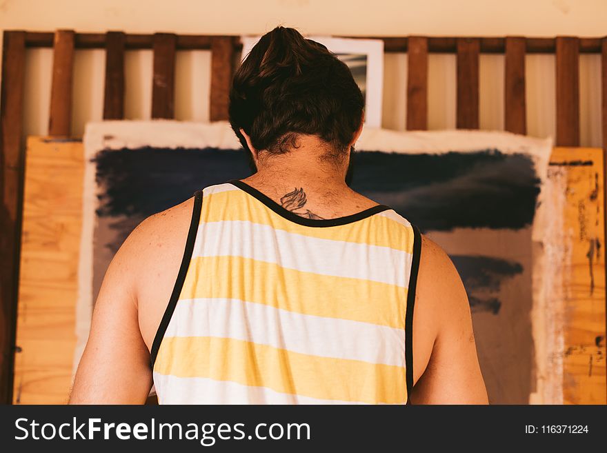 Man Wearing Yellow And White Tank Top