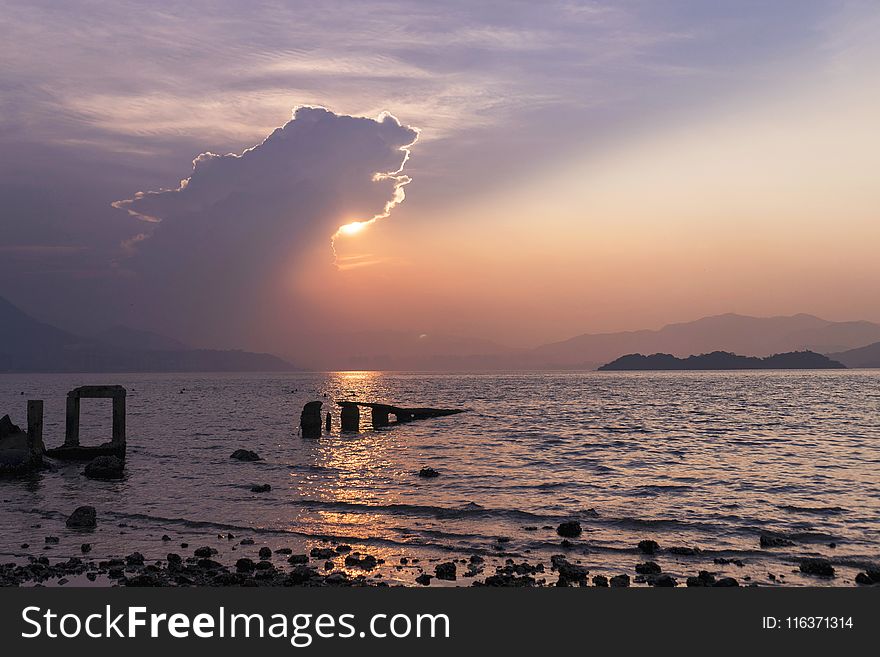 Seashore Under Cloudy Sky in Golden Hour Photography