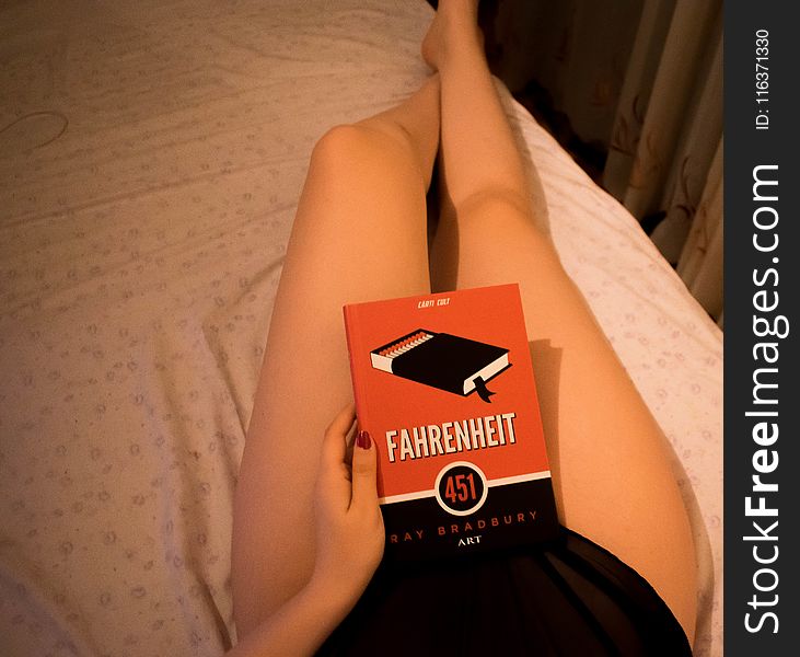 Person Lying On Bed Holding Fahrenheit Box