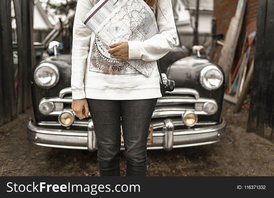 Person Holding Map With Car at the Back