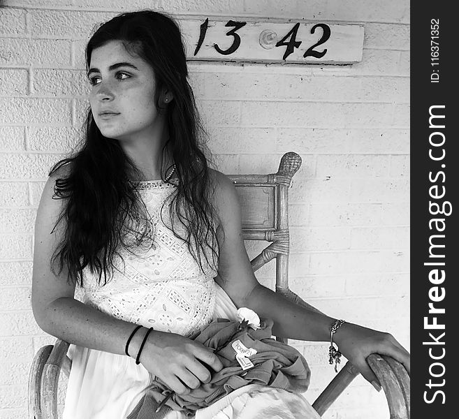 Grayscale Photo Of Girl Sitting On Armchair