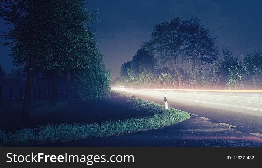 Time Lapse Photograph of Gray Road Near Trees