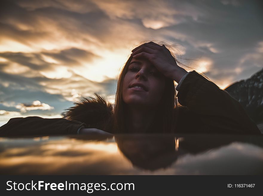 Woman Wearing Brown and Green Parka at Golden Hour