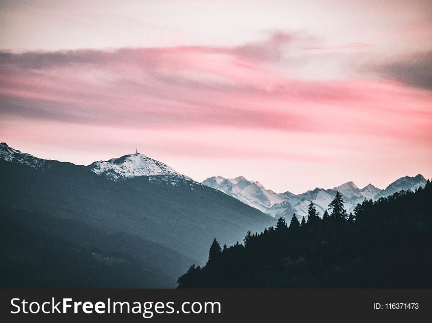 Snow Capped Mountains Under the Cloudy Skies