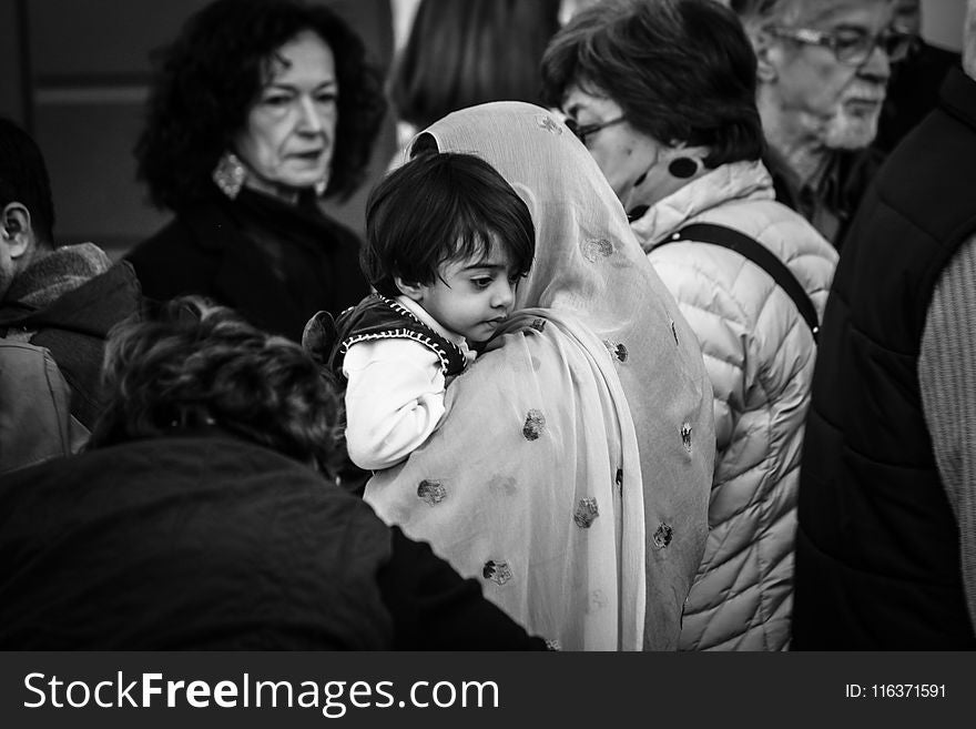 Grescale Photography of Woman Carrying Boy