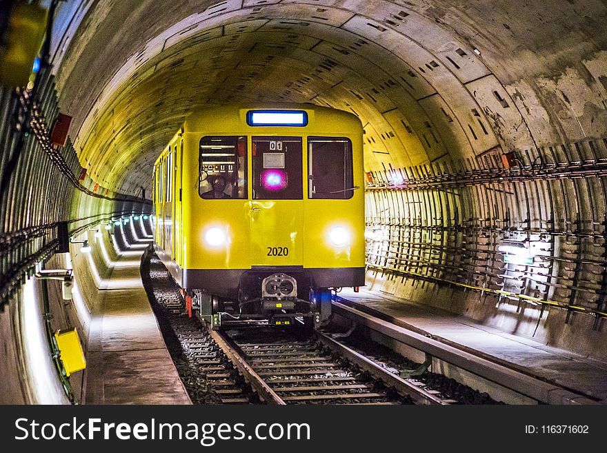 Yellow and Black Train Under Tunnel
