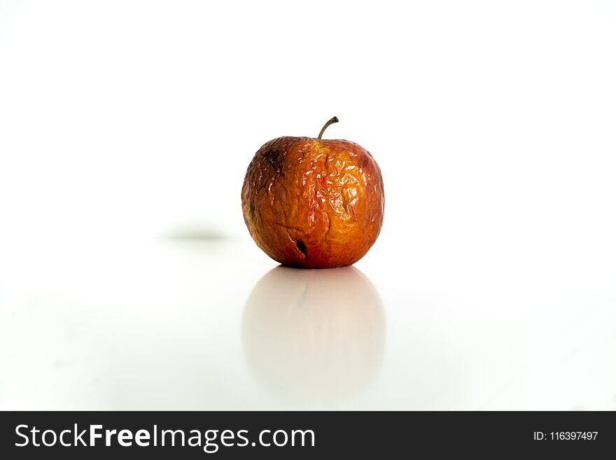 Old red-apple with wounds on white background. Old red-apple with wounds on white background