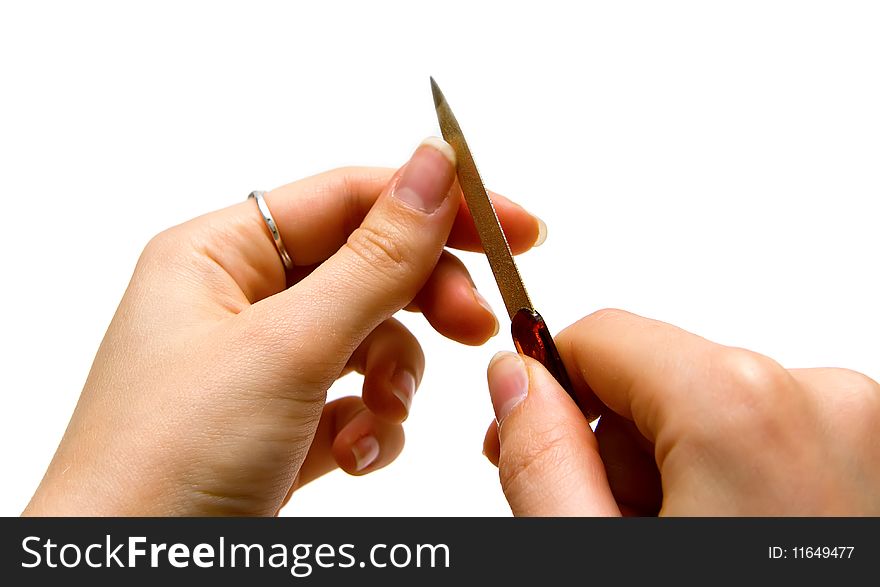 Isolated womans hands using nail file. Isolated womans hands using nail file