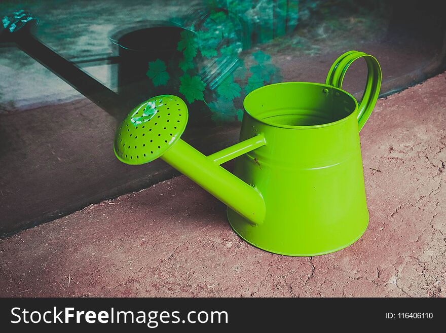 Watering can on the garden close up shoot. Photo depicts bright