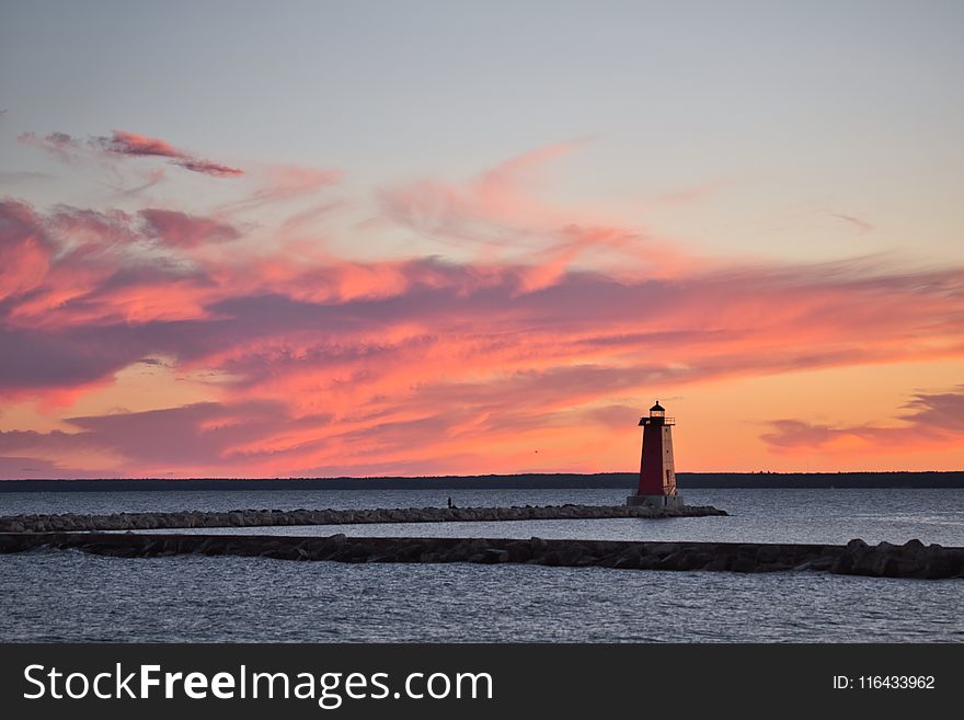 Lighthouse Surrounded By Body Of Water