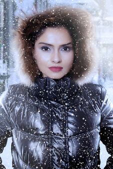 Indian Woman Wearing A Winter Jacket Under Snowfall Stock Photos