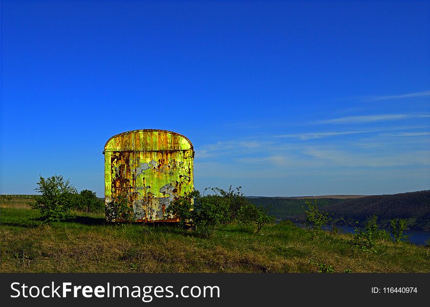 Iron rusty container on the meadow