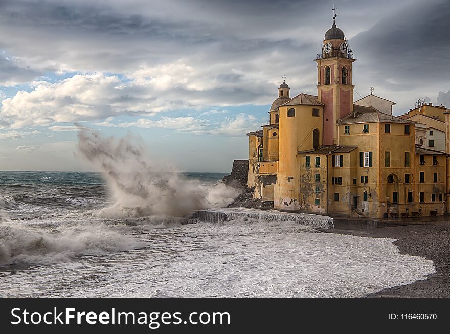 The church and the big wave in Camogli Genoa, Italy, Europe.