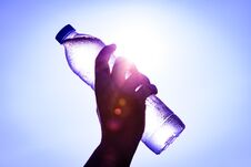 Silhouette Of Closeup Woman`s Hand Holding Plastic Water Bottle Royalty Free Stock Image