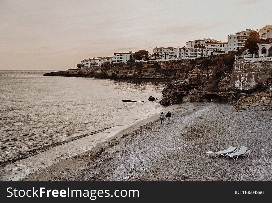 Two Person Walking on Seashore