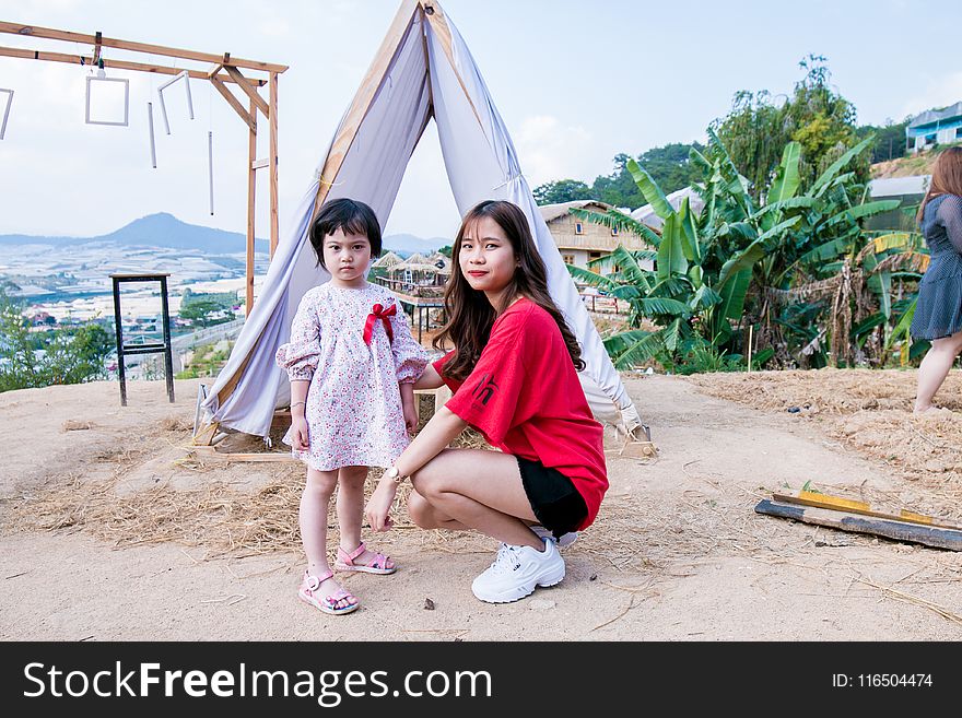 Woman Beside Gift in Front of Tent