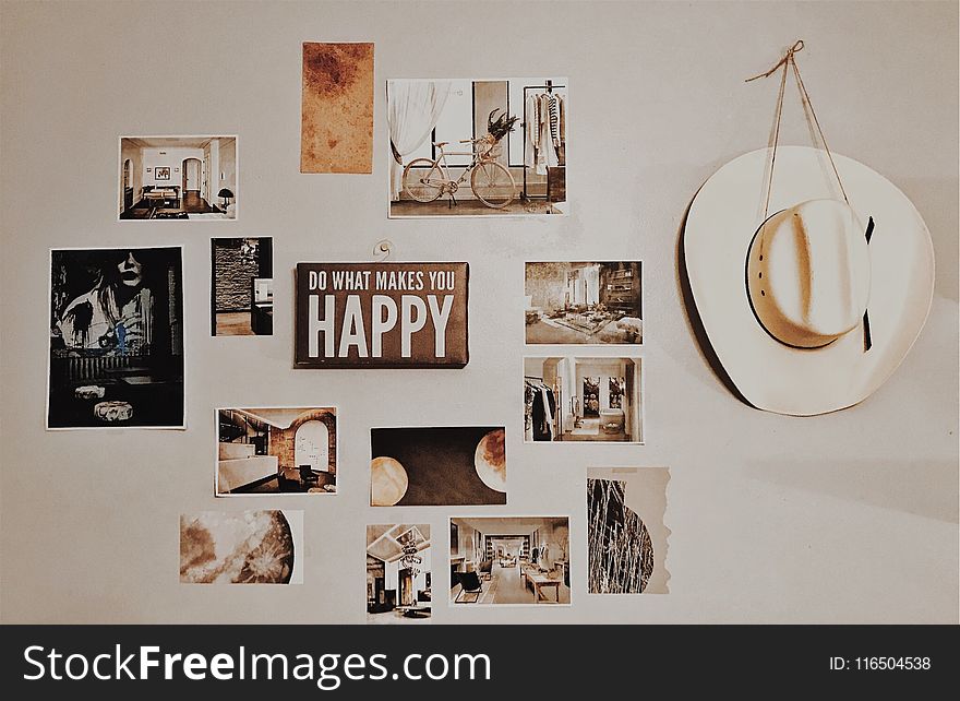 Photo of Brown and White Photo Frames Hang in Wall