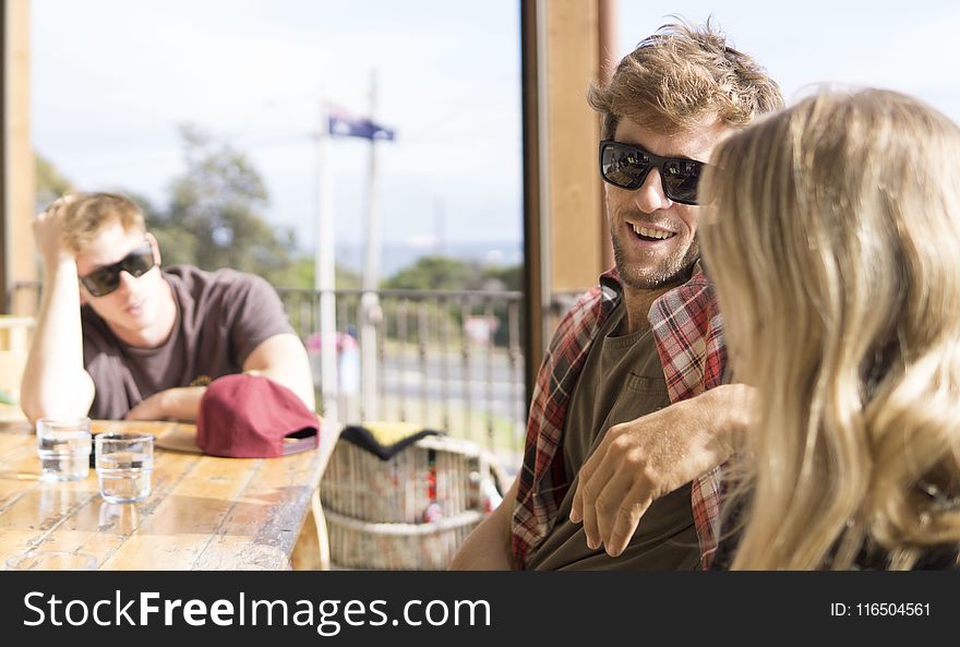 Man Sitting Beside Woman in Front of Table