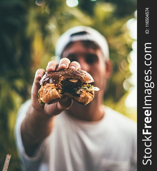 Photo of Person Holding Burger