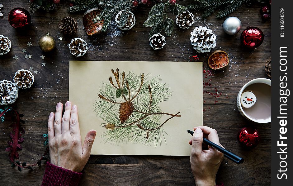 Person Writing Fruit on Printed Paper