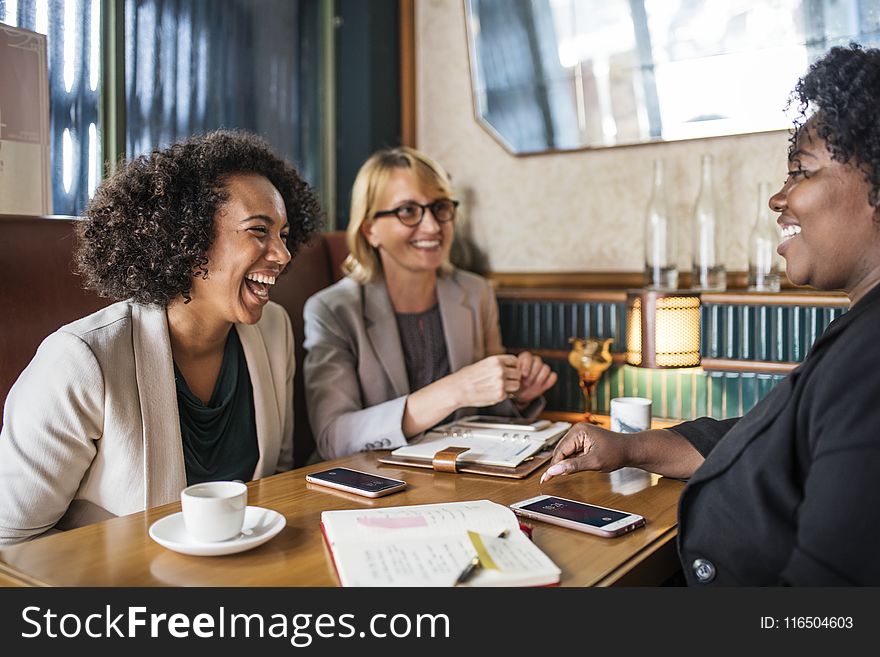 Three Woman Sitting Smiling Inside Room