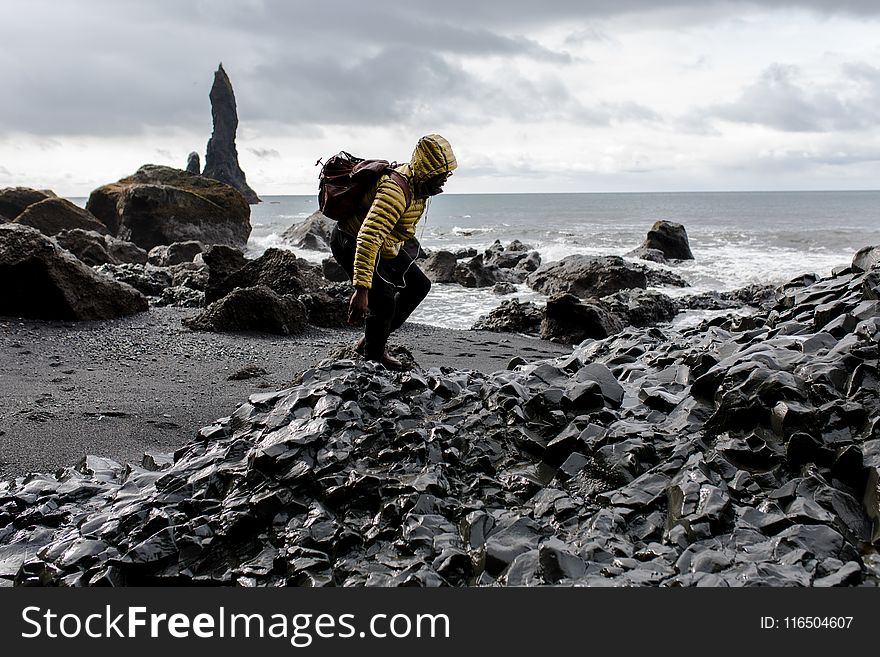 Photo Of Man In Yellow Hoodie Near Seashore