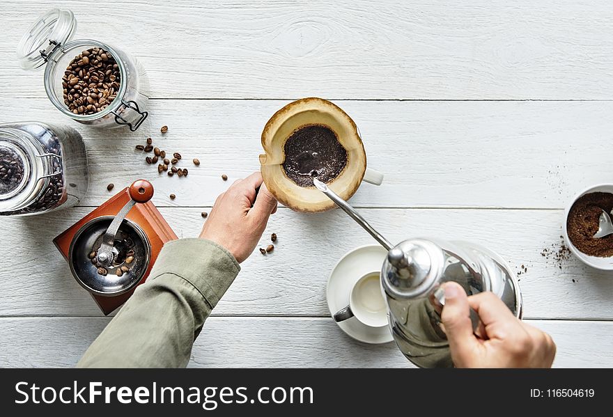 Person Pouring Hot Water in Mug With Ground Coffee