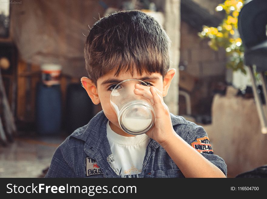 Boy Holding Clear Drinking Glass