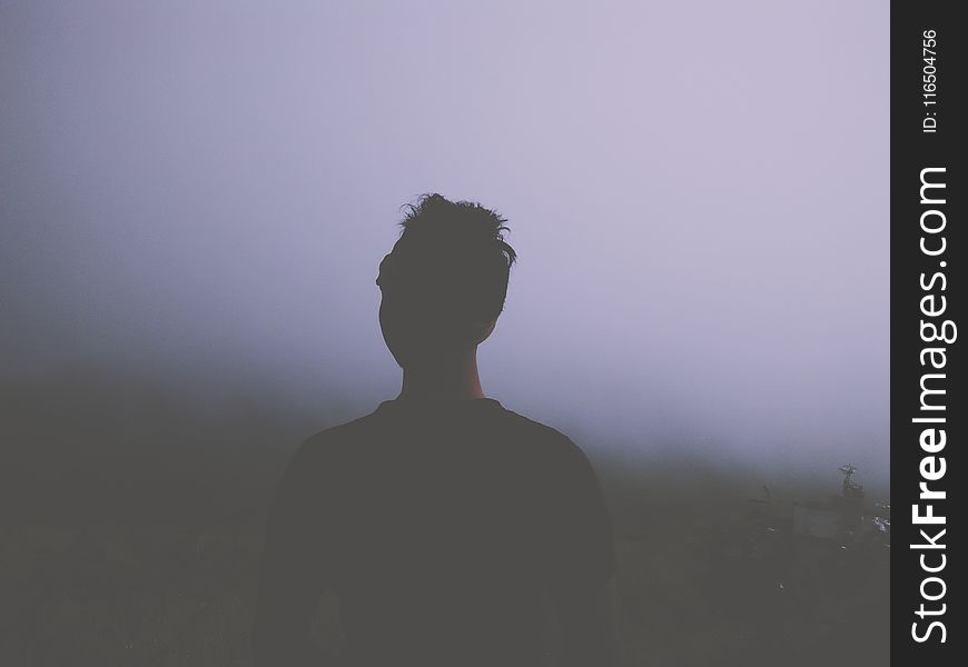 Man Standing Facing White Fogs