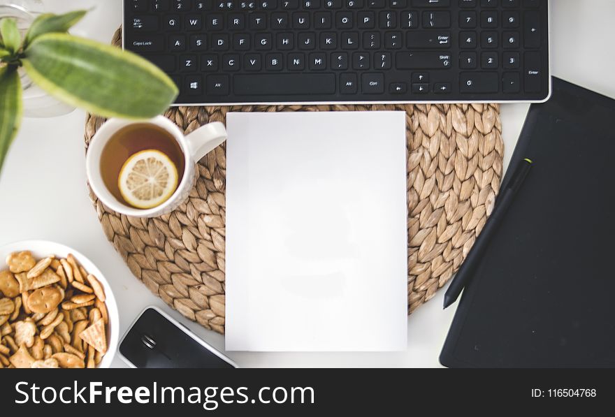 White Printing Paper Near Black Computer Keyboard