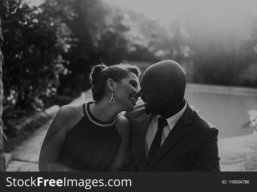 Grayscale Photo of Couple at Garden Near Pool