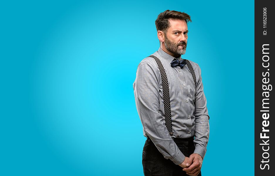 Middle age man, with beard and bow tie doubt expression, confuse and wonder concept, uncertain future. Middle age man, with beard and bow tie doubt expression, confuse and wonder concept, uncertain future