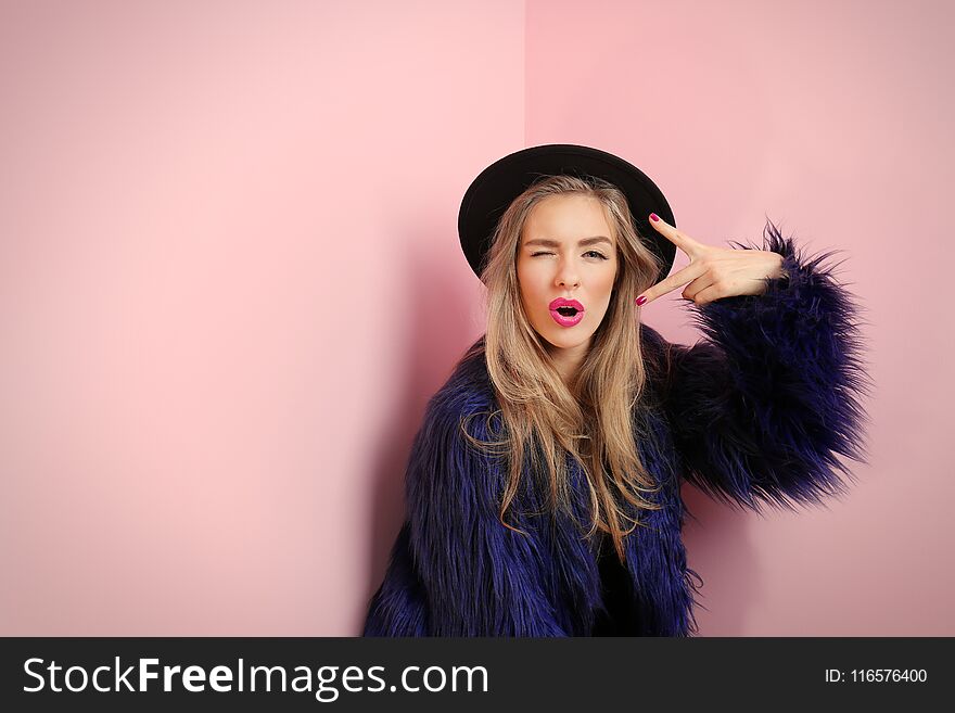 Young cool woman on wall background