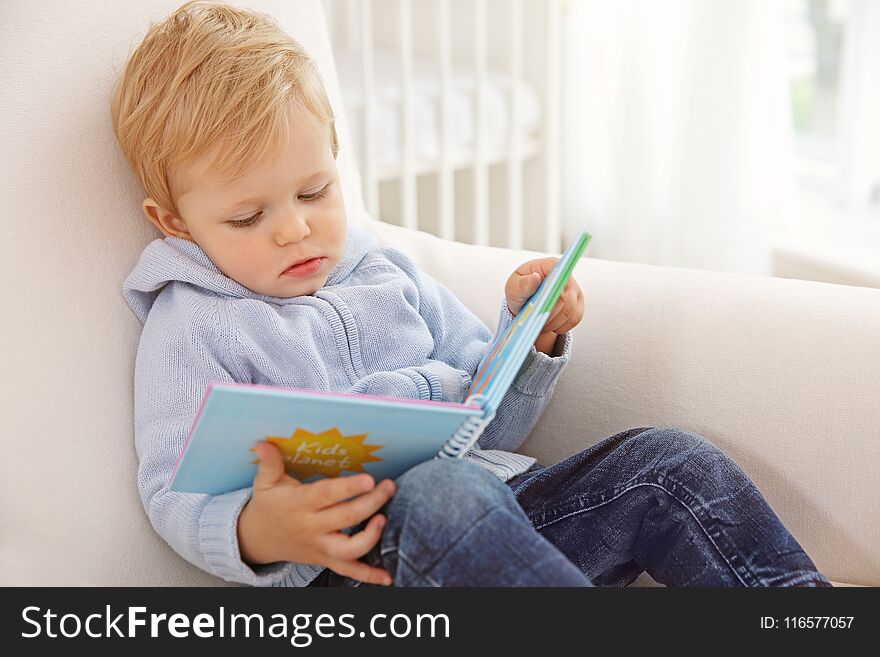 Cute Baby Boy Holding Book