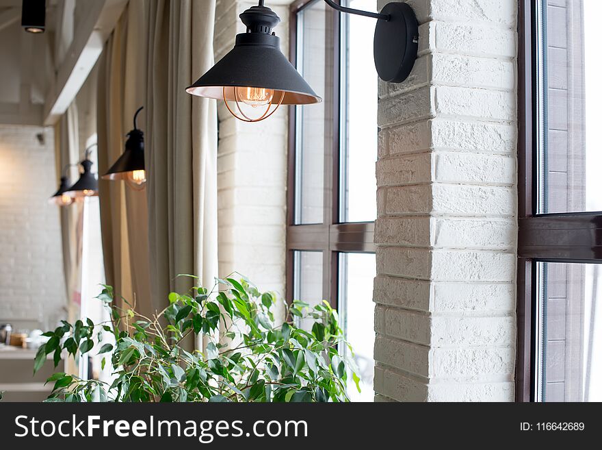 A Lamp On The Background Of A Window And A Wall With Curtains