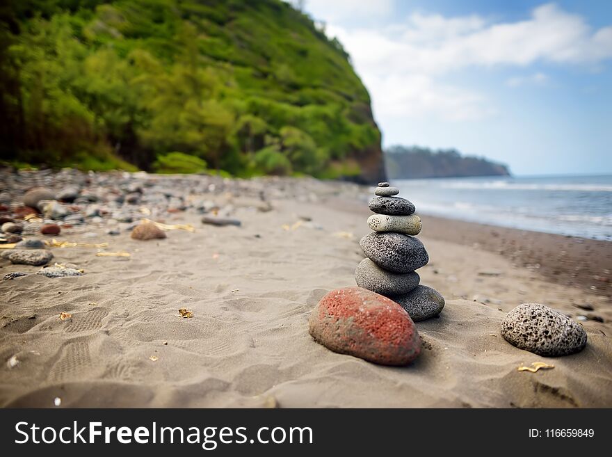 Stack of stones balanced on rocky beach of Pololu Valley, Big Island, Hawaii
