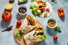 Healthy Vegan Lunch Snack. Tortilla Wraps With Mushrooms, Fresh Vegetables And Ingredients On Concrete Background. Stock Photography
