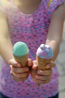Little Pretty Girls Holding Two Ice Cream Cones In Hands. Green Blue Ice Cream Cones. Summer Time. Royalty Free Stock Images