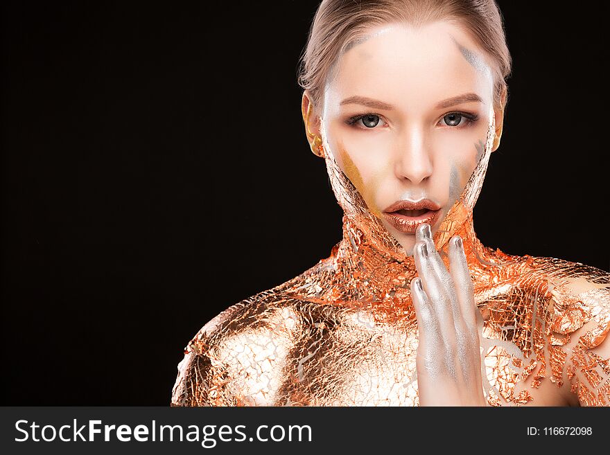 Beauty portrait of lovely blonde woman with creative makeup and golden foil on her shoulders. Space for text. Beauty portrait of lovely blonde woman with creative makeup and golden foil on her shoulders. Space for text