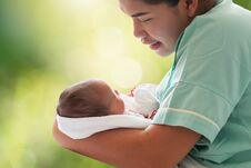 Mother Holding Newborn Infant Baby Girl In Arm On Blurred Bokeh Royalty Free Stock Photography